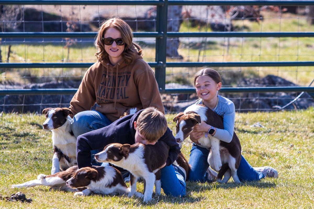 Cassi and kids with ranch puppies